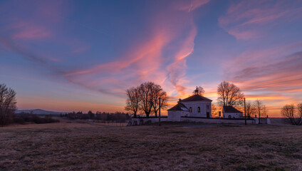 Winter sunset with color sky near Andelska Hora village with ruins and chapel