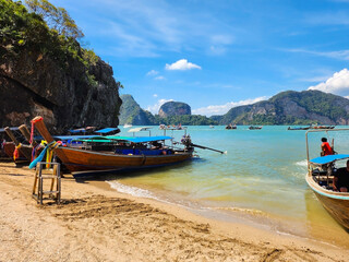Fototapeta na wymiar Thailand - January 2023: Thai traditional tourist boats off the coast of Koh Tapu island
