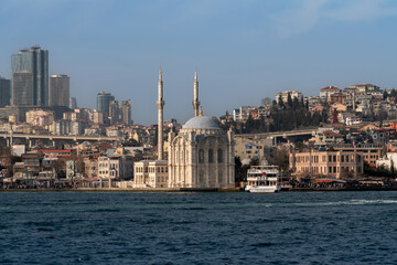 Fototapeta na wymiar Ortakoy Mosque (Buyuk Medjidie Kamii) in Besiktas district on the embankment of the Ortakoy Pier Square from the waters of the Bosphorus, Istanbul, Turkey
