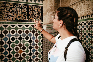 girl with braids touching tiles