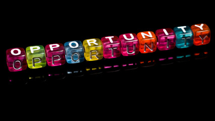 word "opportunity" written in colorful cubes isolated on dark background. the concept of taking advantage of opportunities in life. writing in colorful blocks with copy space area. symbols 