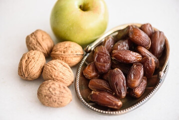 Something of various healthy superfoods on white marble kitchen table background. Ingredients for the preparation of the apple charoset for the Passover