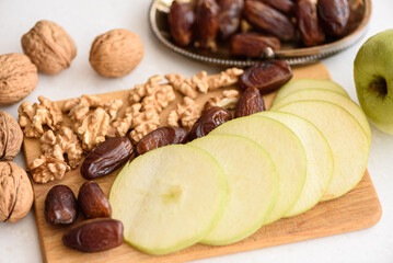 Something of various healthy superfoods on white marble kitchen table background. Ingredients for the preparation of the apple charoset for the Passover