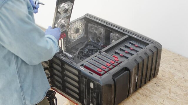 Blowing computer cabinet with air compressor. Computer repair service concept