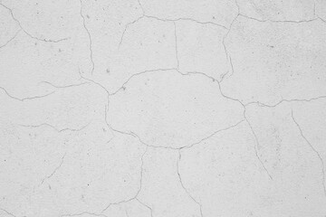 Fototapeta premium Wall with gray cracked stucco.