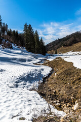 Fototapeta na wymiar Alpine landscape at the end of winter, partly covered with snow