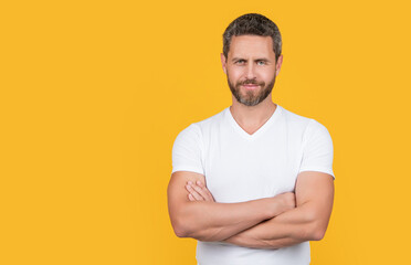 bearded man in casual shirt isolated on yellow background with copy space.