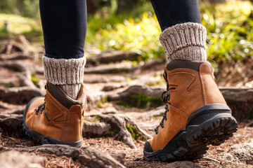 Hiking boot. Walk on trekking trail in forest. Leather ankle boots