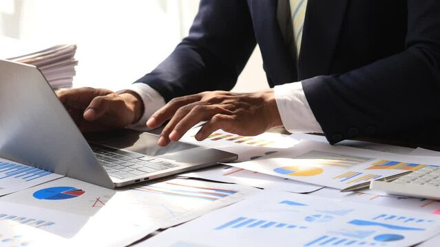 Businessman sits in a private office at his company and is reviewing company financial documents, senior management checking financial information for accuracy. Financial management. copy space