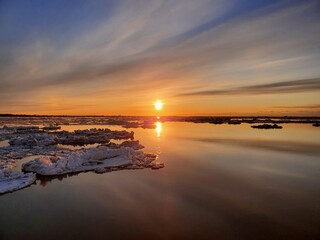 Ice drift, ice floes float on the river in early spring, Ice drift on the river in the orange light...
