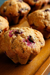 Homemade blueberry muffins on a wooden serving tray. Close-up. 