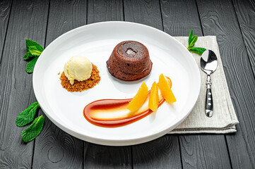 Tasty fondant with ice cream poured with caramel