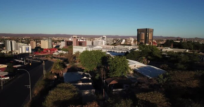 4K aerial drone footage of green hills in city center on sunny morning in Windhoek, the capital of Namibia, southern Africa