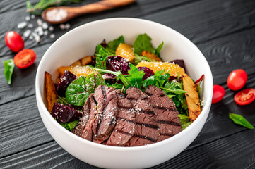 Salad with roast beef and caramelized beets with orange fillet, potatoes, parmesan, salad mix and...