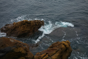 Waves in the ocean crash against the rocks