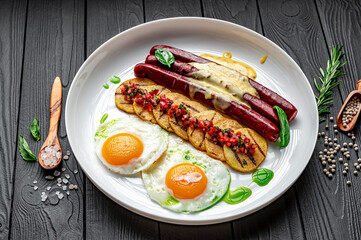 Breakfast with sausages, eggs and potatoes with vegetable salsa and Golan sauce