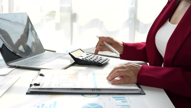 Business person accountant using calculator for calculating finance on desk office. business financial accounting concept