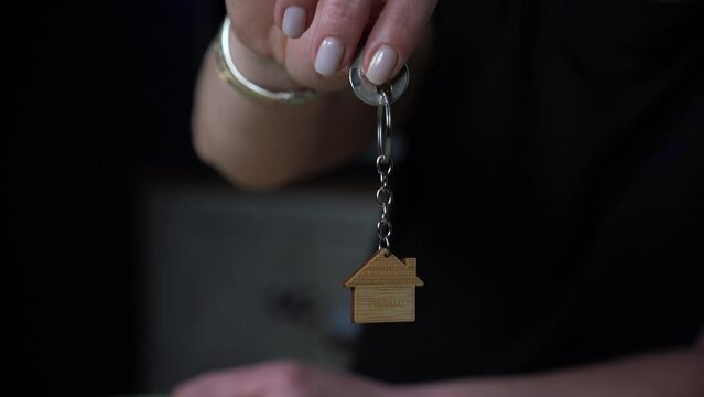 house sale. Happy woman buying new house with mortgage. Woman gets new keys to her house