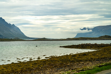 Mountain scenery in Lofoten, Norway, during a sunny day with clouds in spring, overlooking the sea