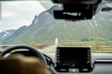 Lofoten roads from inside a car on the mountain roads in Norway during a sunny spring day, copy...