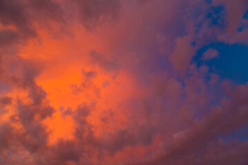 the setting sun deep blue and the clouds are purple.