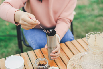 Obraz na płótnie Canvas Drip coffee on vacation outdoor and drinking a cup of hand coffee in autumn morning. relax and enjoy outdoor lifestyle and holiday travel vacation.