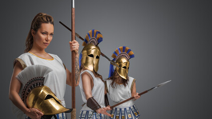 Studio shot of greek female warriors from past dressed in white tunics.