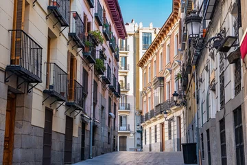 Papier Peint photo Madrid Picturesque alley with old buildings, windows and terraces with bars in the city of Madrid, Spain.