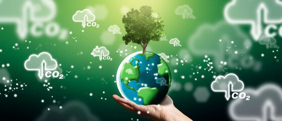 Zero emissions and carbon neutral concept in the Man´s hands holding the green planet earth....