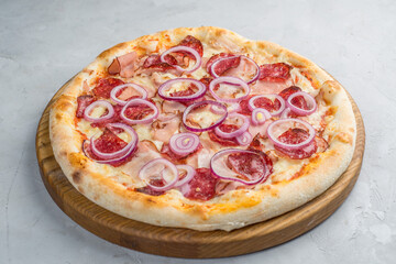 Pizza with vegetables, sausages and ham