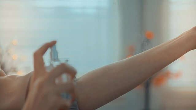 woman savors luxurious scent, spraying fine mist her wrist