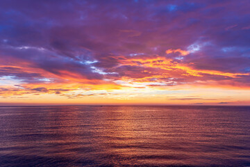 view at sunrise or sunset in sea with nice beach , surf , calm water and beautiful clouds on a background of a sea landscape