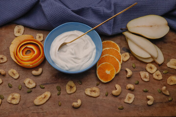 Fototapeta na wymiar Bowl with Greek yogurt and fruit with nuts, seeds