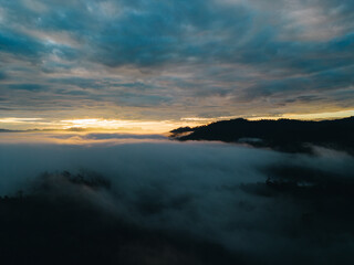 Fototapeta na wymiar Mountain range and mist with sky and sunrise and surrounding area.