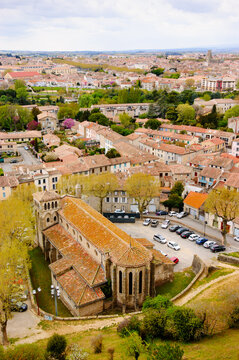 View from Castle of Carcassonne walls on Saint Gimer's Church and city streets. Carcassonne, France. Aerial ciityscape backgound. 