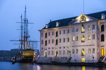 The National Maritime Museum in Amsterdam with a galleon at dock in front