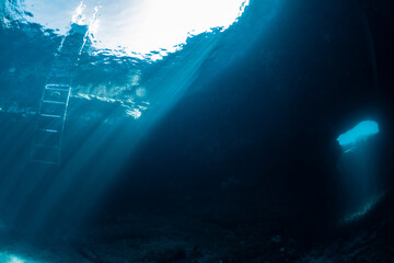 Exploring the swim throughs in between the natural pool of las Piscinas Naturales Los Abrigos Tenerife Canary Islands