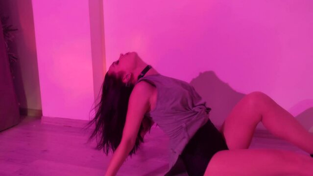 Woman with choker and high heels is dancing on the floor, tempting female body