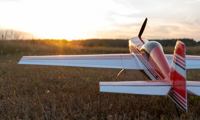 airplane model on the runway at sunset