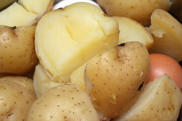 boiled potatoes with egg. potatoes cut and unpeeled. food details. potato texture.