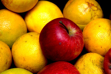 apples and oranges. red apple with oranges. fruit set. apple among the fruits.