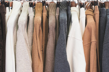 Fashion clothes on clothing rack  Closeup of rainbow color choice female wear on hangers in store...