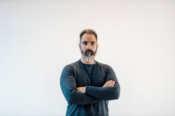 Portrait of a serious middle-ages businessman looking at the camera.