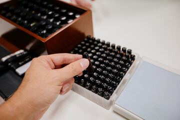 Hand holding aroma sample from sample kit box