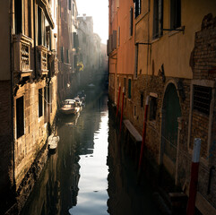 Fototapeta na wymiar Venice canal with a sunbeam early in the morning