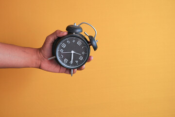  person hand holding alarm clock white background ,