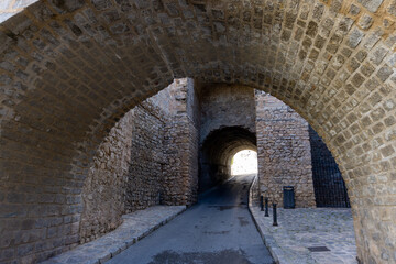 Fototapeta premium City walls of Ibiza, with a medieval gate on a sunny day without tourists.