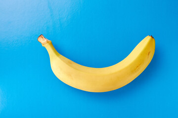 Yellow ripe banana on a blue background.