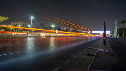 Fototapeta na wymiar Abstract movement blur of car traffic with long exposure on Cairo street at night