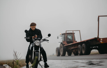 man on a motorcycle in motorcycle clothes in the rain and fog in the cold. Motorcycle travel.